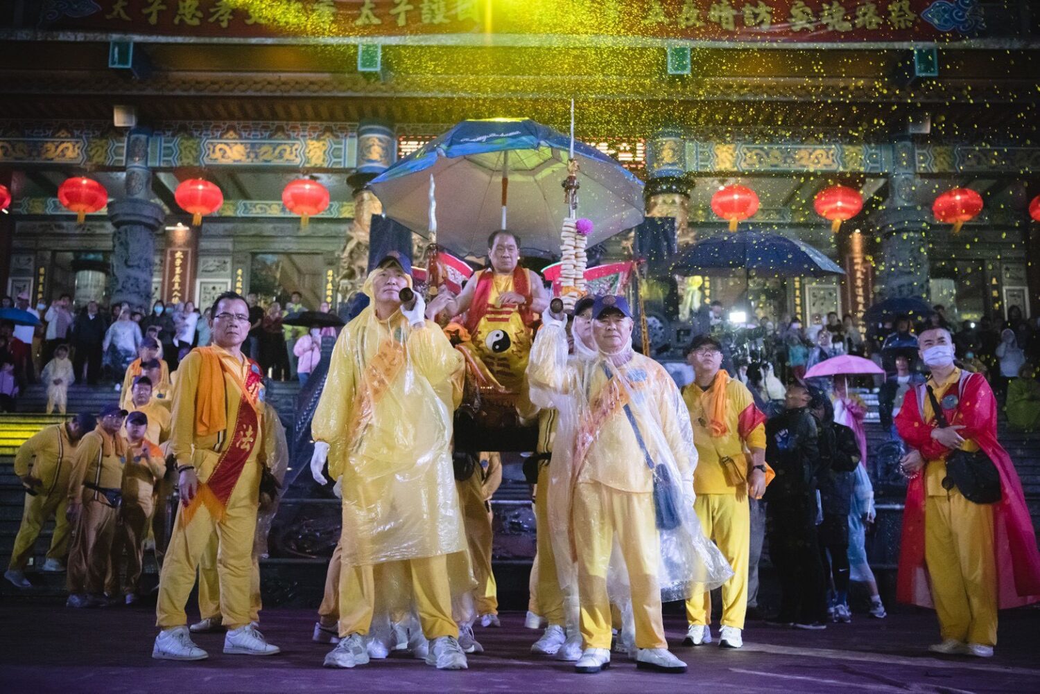 桃園護國宮太子爺「五夜暗訪」風雨中回鑾，太子爺在閱兵台上陣頭一一參禮，頭家們和貴賓扛著釘椅恭迎聖駕。（圖／桃園護國宮提供）